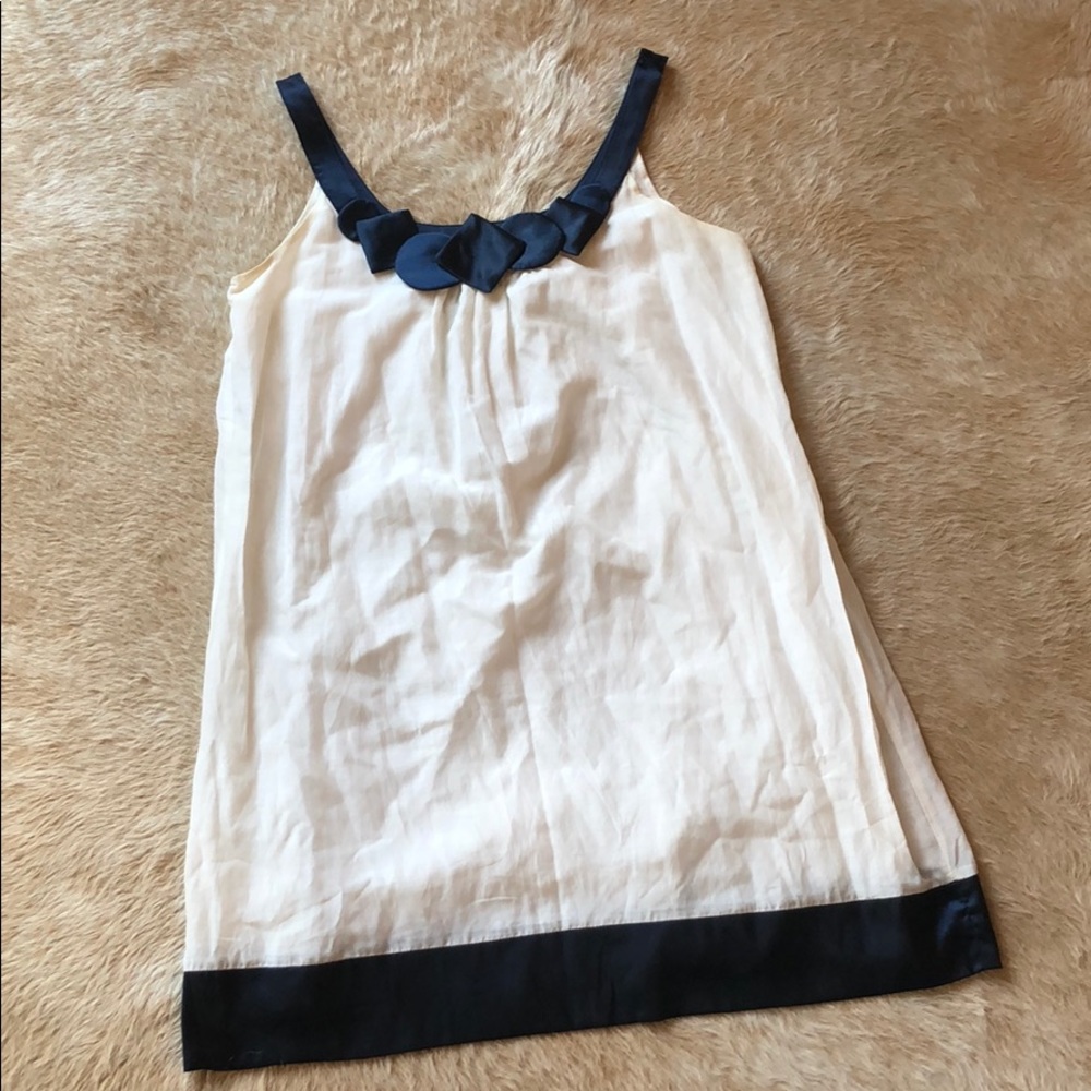 White Dress with Navy Neckline and Hem Detail